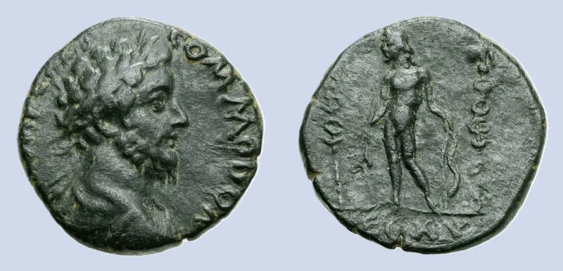 Legionary ARMENIA Satala Commodus AD 177-192 AE Bronze (24mm 9,16g) IMP CAES COMOΔO AV. Laureate, draped and cuirassed bust right  LEG XV Apollo standing left, holding branch and bow between Standards