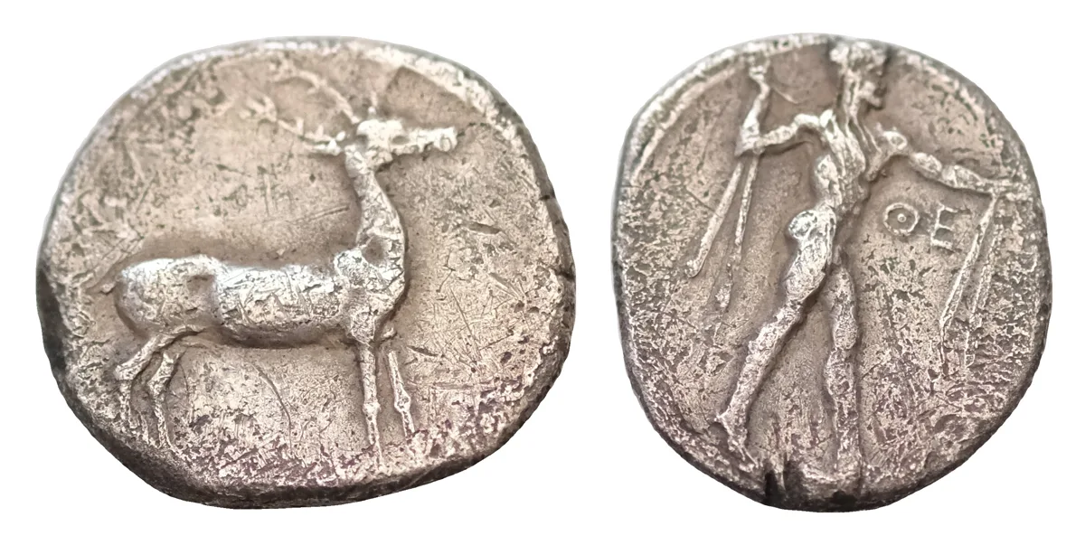 Bruttium, Kaulonia AR 21mm 7,5g. Stater. c. 475-425 BC. Nude Apollo walking to right, holding laurel branch in upright right hand, KAVΛ downwards to left / Stag standing to right